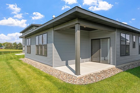 a small with a porch and a grassy yard